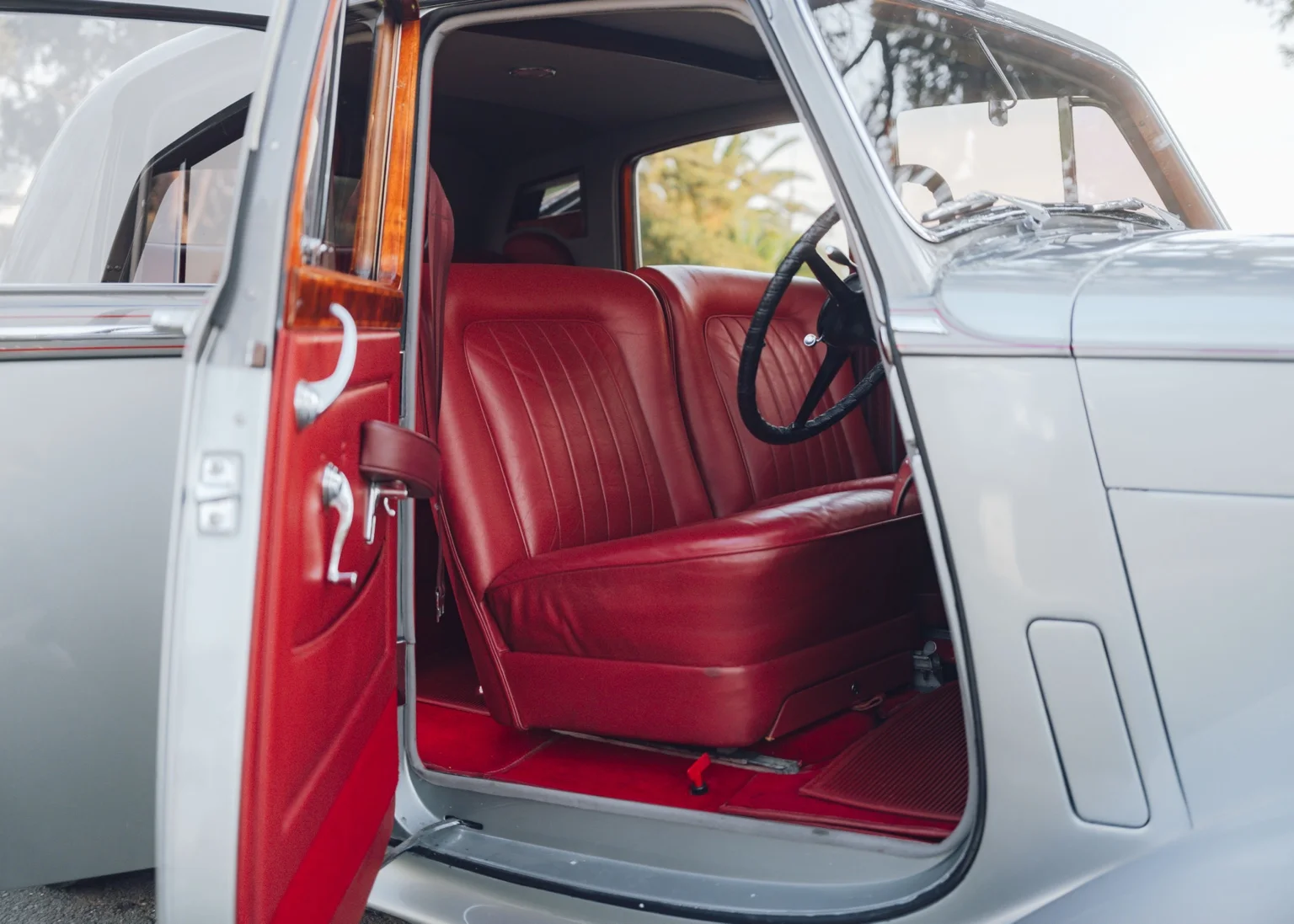 The Bentley’s red leather front seats, wooden door trim and steering wheel